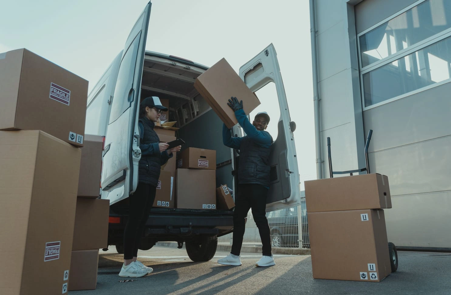 Courier team loading parcels into a van